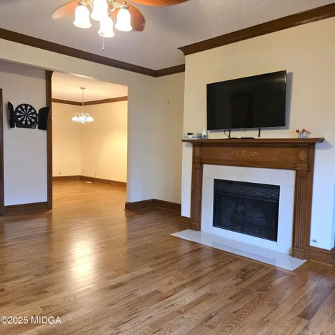 a living room with furniture wooden floor and a fireplace