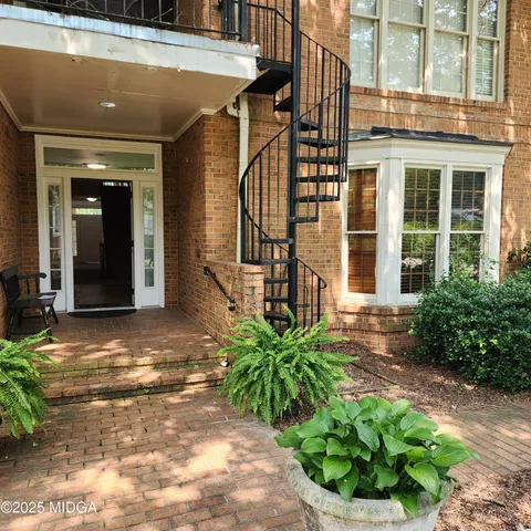 a view of a house with potted plants