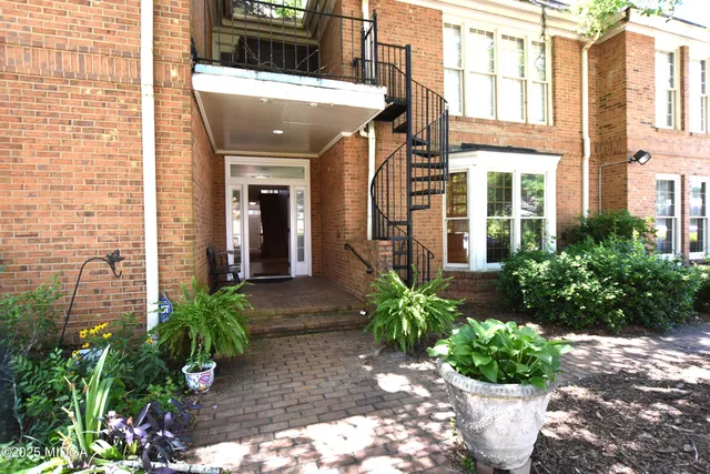 a view of a building with potted plants