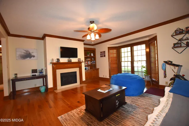 a living room with furniture fireplace and flat screen tv