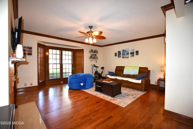 a living room with furniture fireplace and a large window