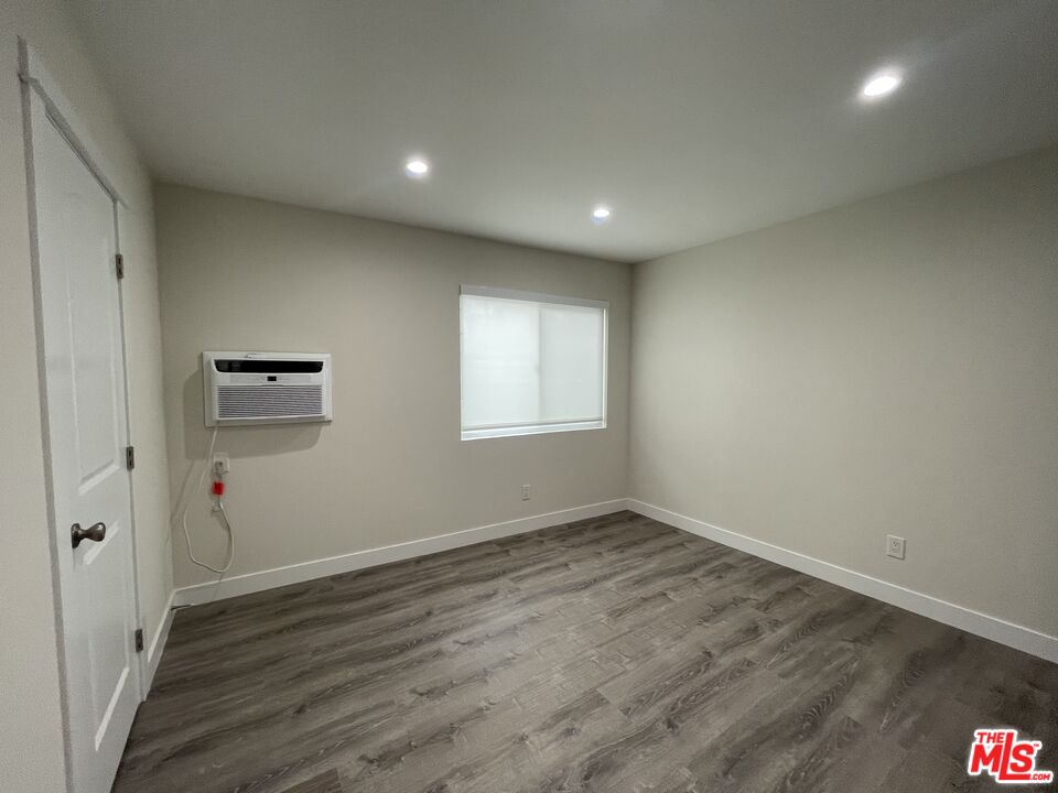 27 Anchorage Street, Unit B Marina del Rey, CA 90292 - Photo 11 of 15 an empty room with wooden floor and windows