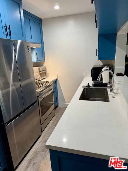 27 Anchorage Street, Unit B Marina del Rey, CA 90292 - Photo 2 of 15 a kitchen with a refrigerator and a stove top oven