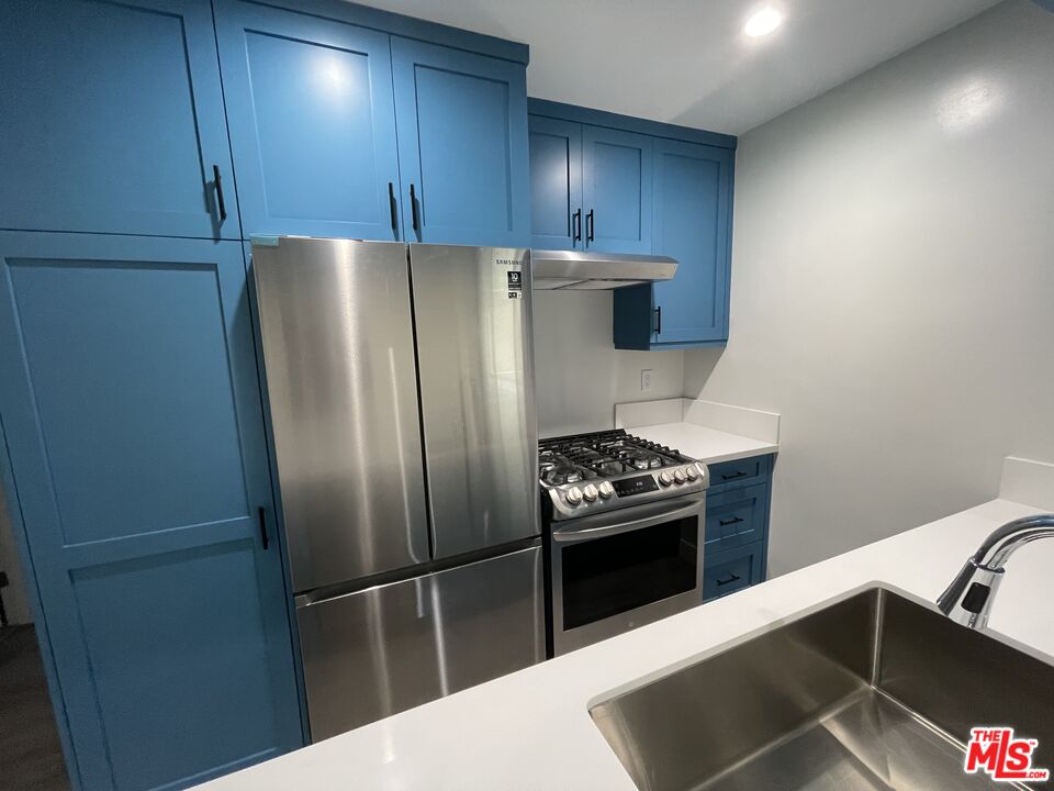 27 Anchorage Street, Unit B Marina del Rey, CA 90292 - Photo 4 of 15 a kitchen with a refrigerator stove and cabinets