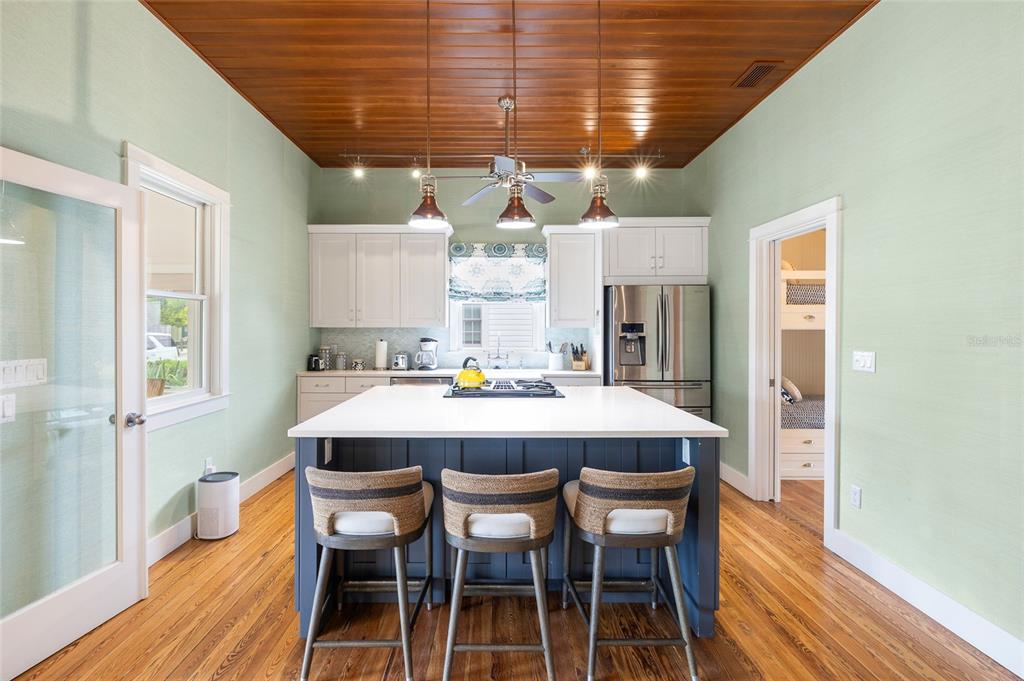 340 Palm Avenue Boca Grande, FL 33921 - Photo 10 of 38 a dining room with stainless steel appliances kitchen island granite countertop a dining table chairs and granite counter tops