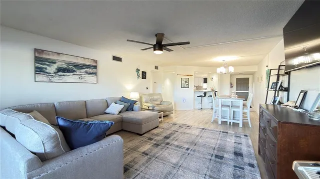 a living room with furniture and a view of kitchen
