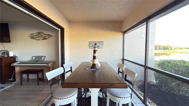 a view of a dining room with furniture window and outside view