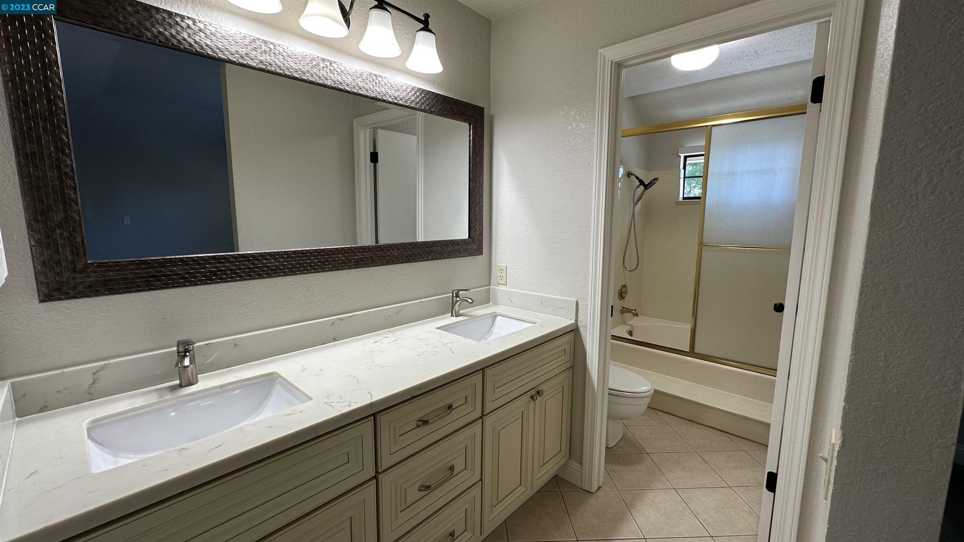 61 Rainbow Circle Danville, CA 94506 - Photo 16 of 22 a bathroom with a double vanity sink and mirror