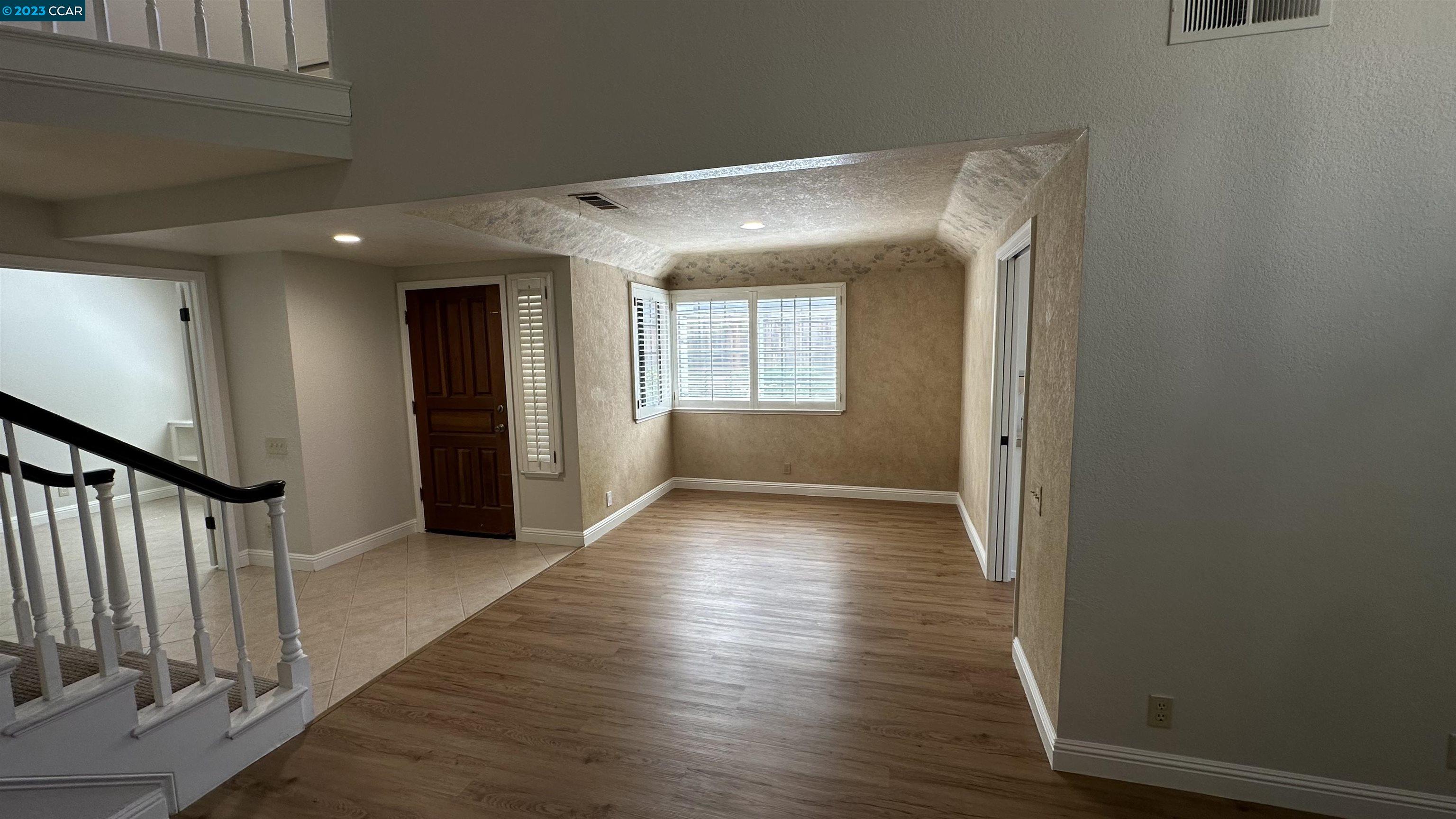 61 Rainbow Circle Danville, CA 94506 - Photo 3 of 22 a view of a hallway with wooden floor and staircase