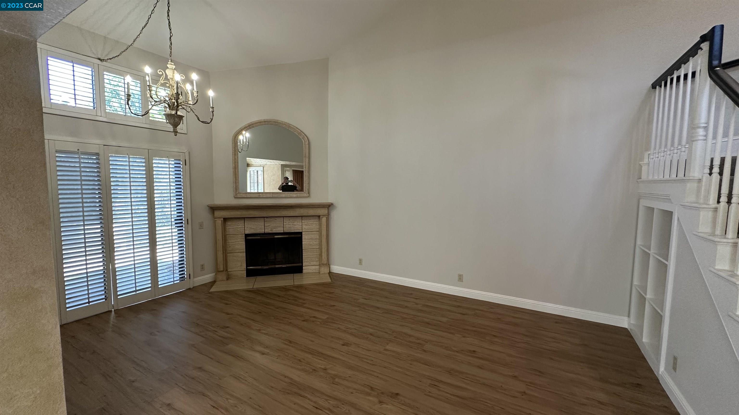 61 Rainbow Circle Danville, CA 94506 - Photo 4 of 22 a view of a livingroom with a fireplace chandelier and wooden floor