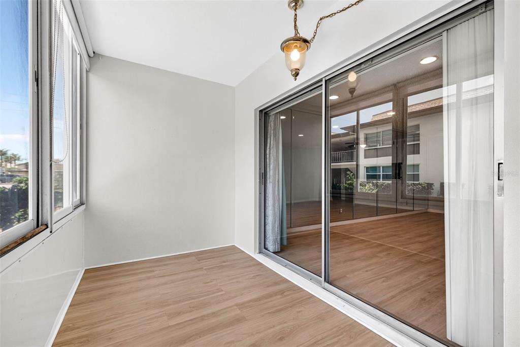 5197 Silent Loop, Unit 124 New Port Richey, FL 34652 - Photo 22 of 55 a view of empty room with wooden floor and windows