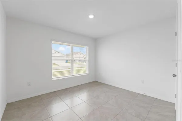 a view of a kitchen with kitchen island and windows