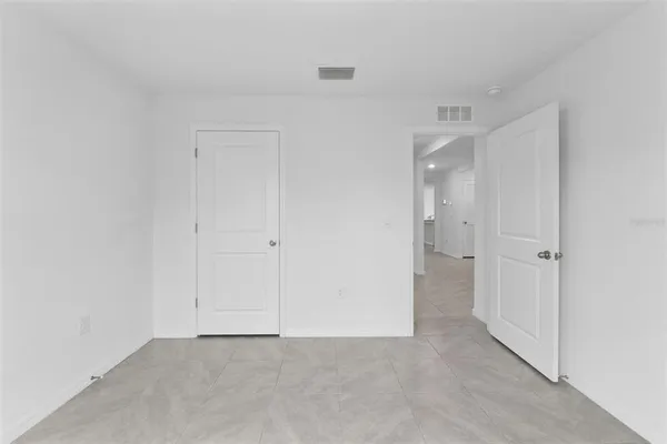 a kitchen with granite countertop a refrigerator and a stove top oven