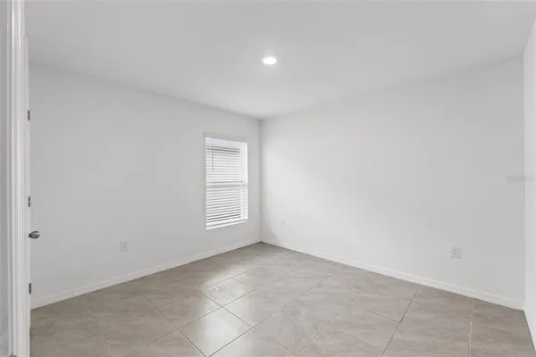 a large kitchen with granite countertop a refrigerator a stove a sink a washer and dryer