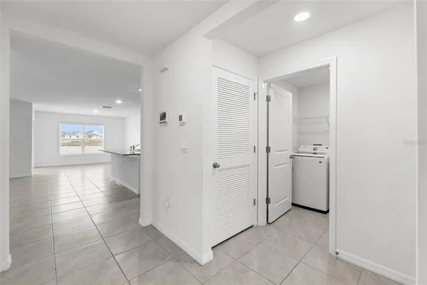 a kitchen with kitchen island granite countertop a sink a counter top space appliances and cabinets