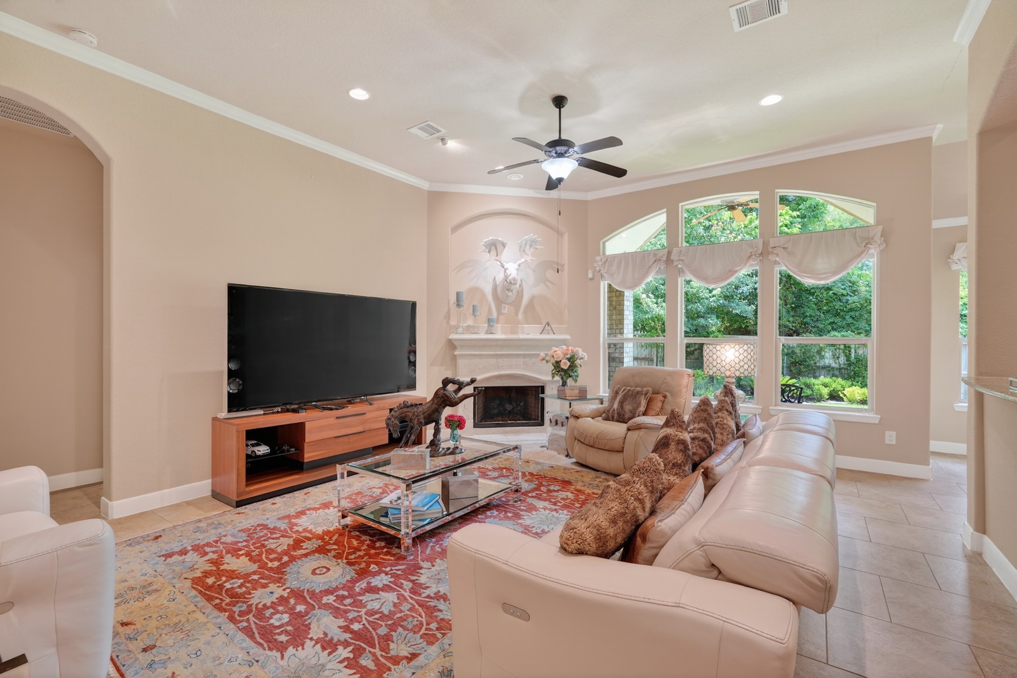 55 South Victoriana Circle Spring, TX 77389 - Photo 13 of 40 a living room with furniture a fireplace and a flat screen tv