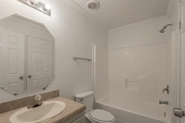 a bathroom with a sink toilet a mirror and shower