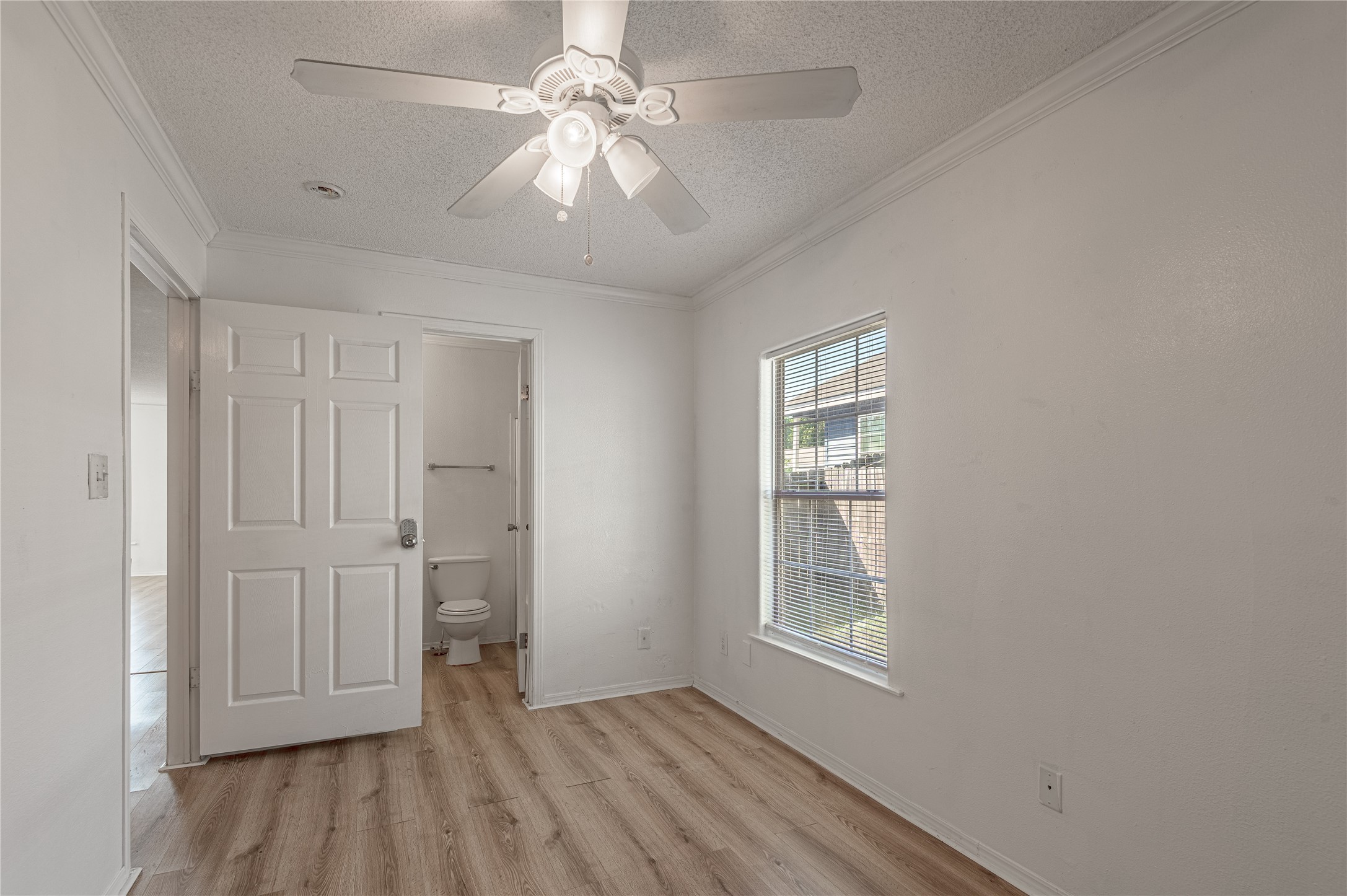 112 Varsity Circle Huntsville, TX 77340 - Photo 15 of 33 wooden floor in an empty room with a window