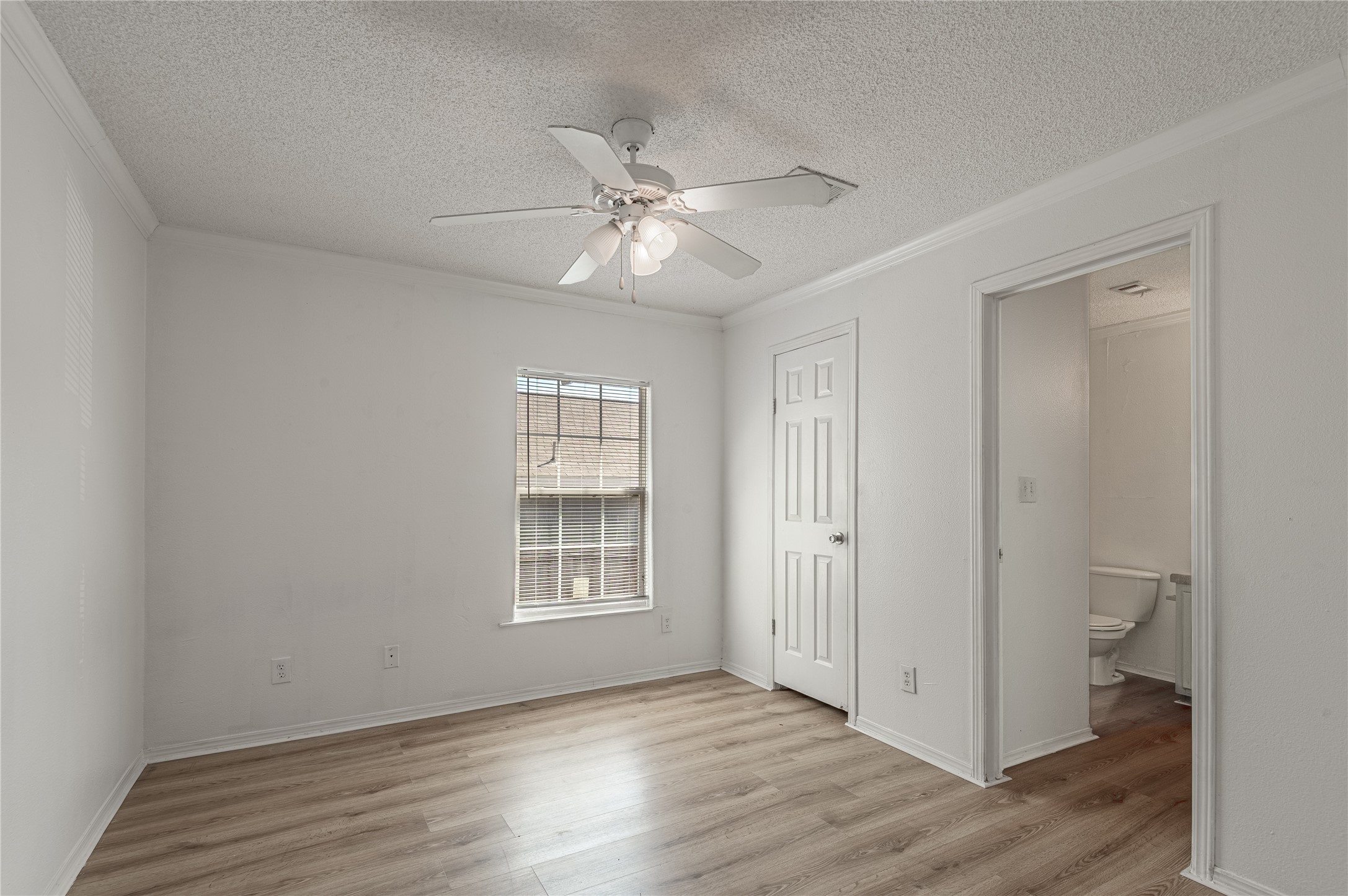 112 Varsity Circle Huntsville, TX 77340 - Photo 17 of 33 wooden floor in an empty room with a window
