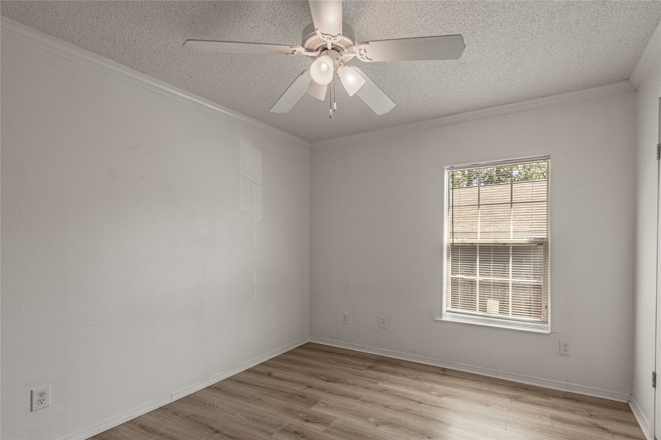 112 Varsity Circle Huntsville, TX 77340 - Photo 18 of 33 an empty room with a window and a fan