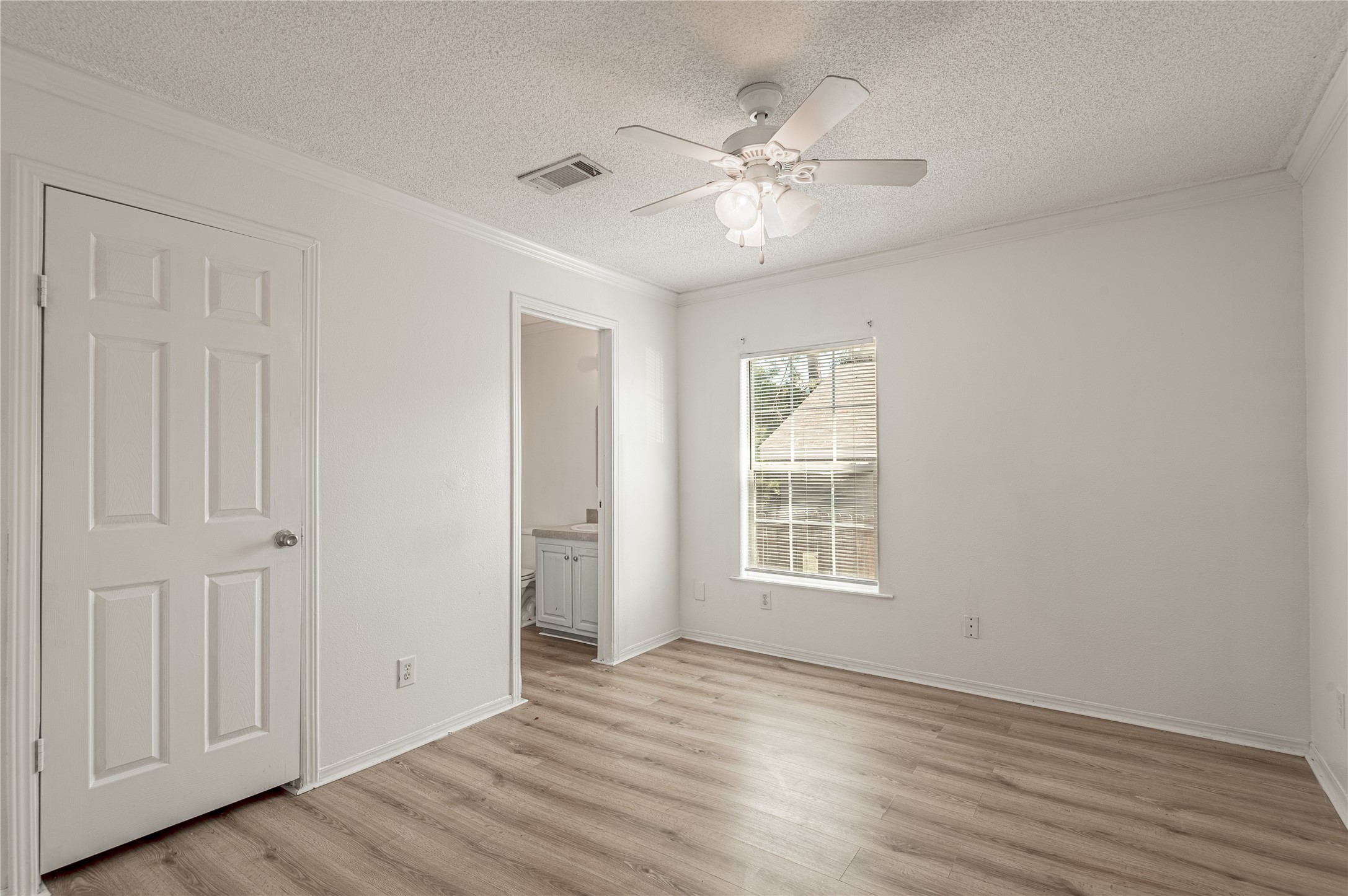 112 Varsity Circle Huntsville, TX 77340 - Photo 21 of 33 a view of an empty room with wooden floor and window