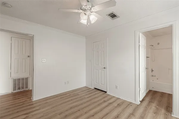 a view of an empty room with wooden floor