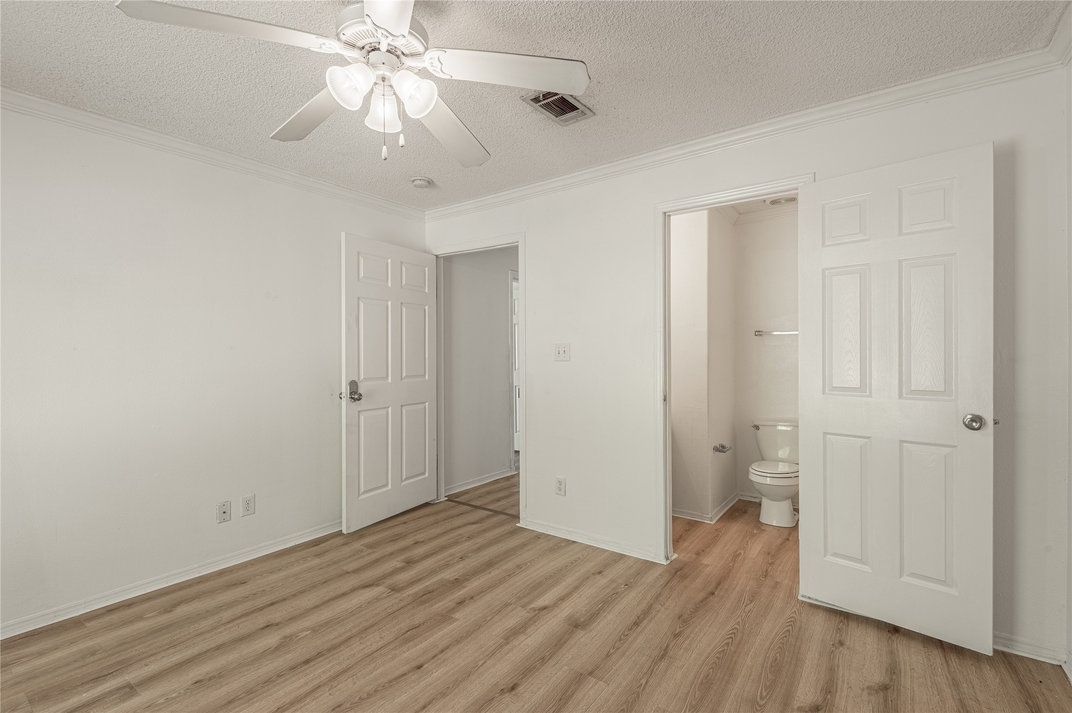 112 Varsity Circle Huntsville, TX 77340 - Photo 26 of 33 an empty room with wooden floor and a ceiling fan