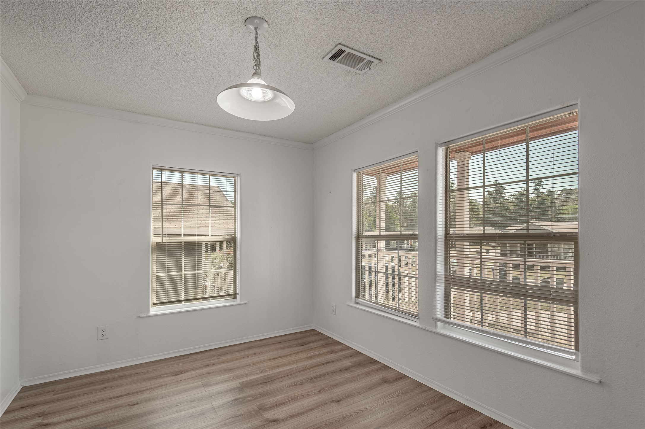112 Varsity Circle Huntsville, TX 77340 - Photo 8 of 33 a view of an empty room with wooden floor and a window