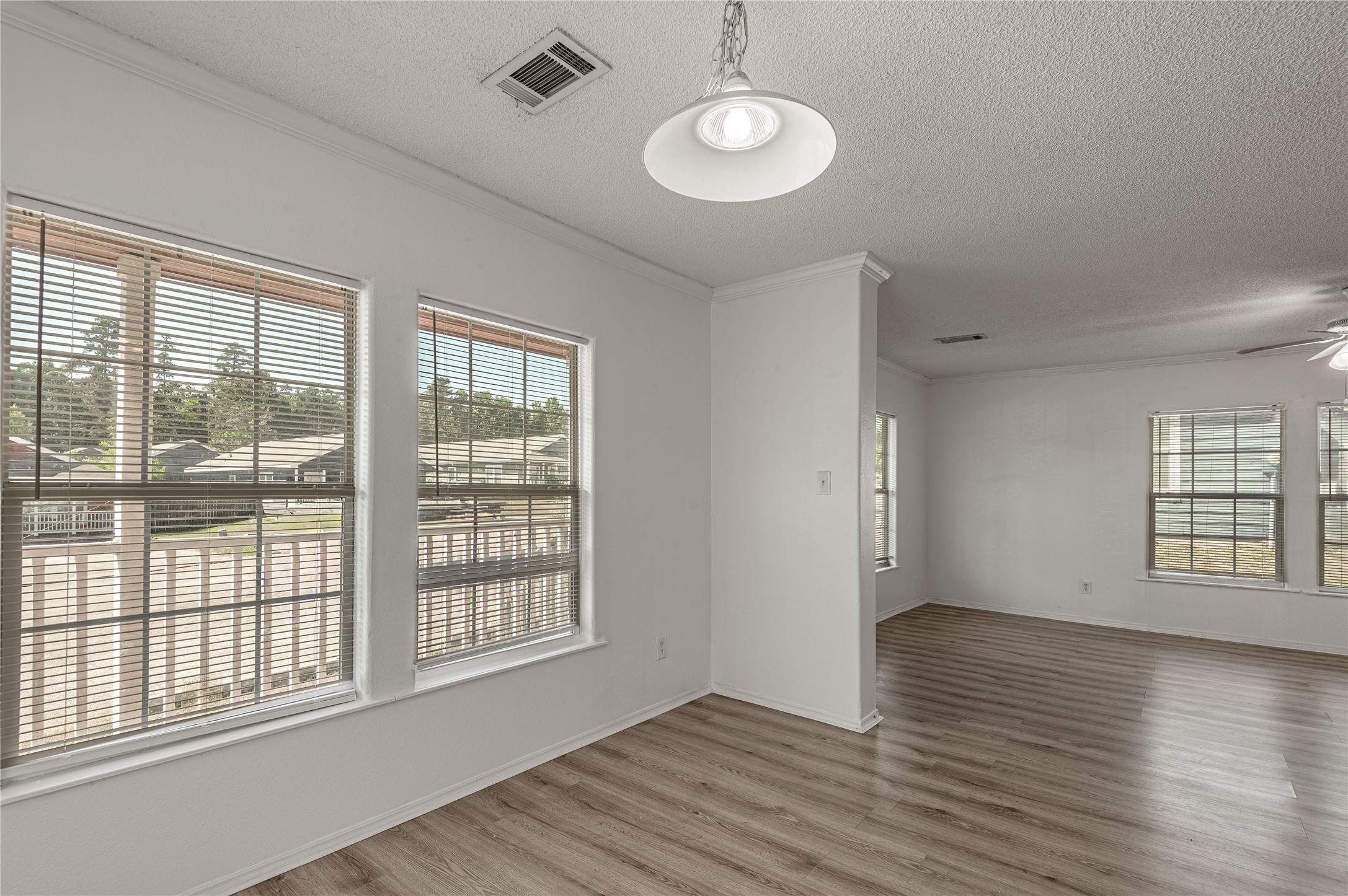 112 Varsity Circle Huntsville, TX 77340 - Photo 9 of 33 a view of an empty room with wooden floor and a window