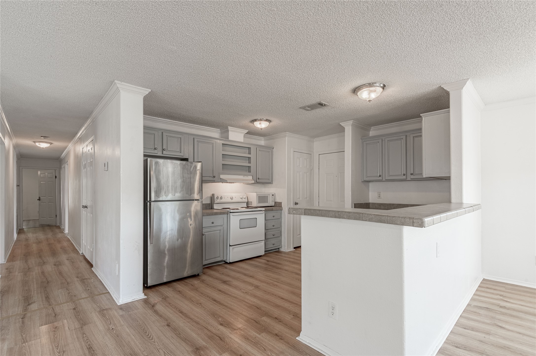112 Varsity Circle Huntsville, TX 77340 - Photo 10 of 33 a kitchen with stainless steel appliances a refrigerator and a stove top oven