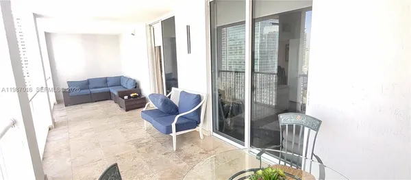 a view of balcony with two chairs and a potted plant