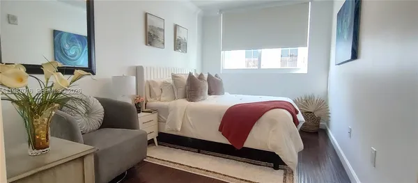 a bedroom with bed and a couch
