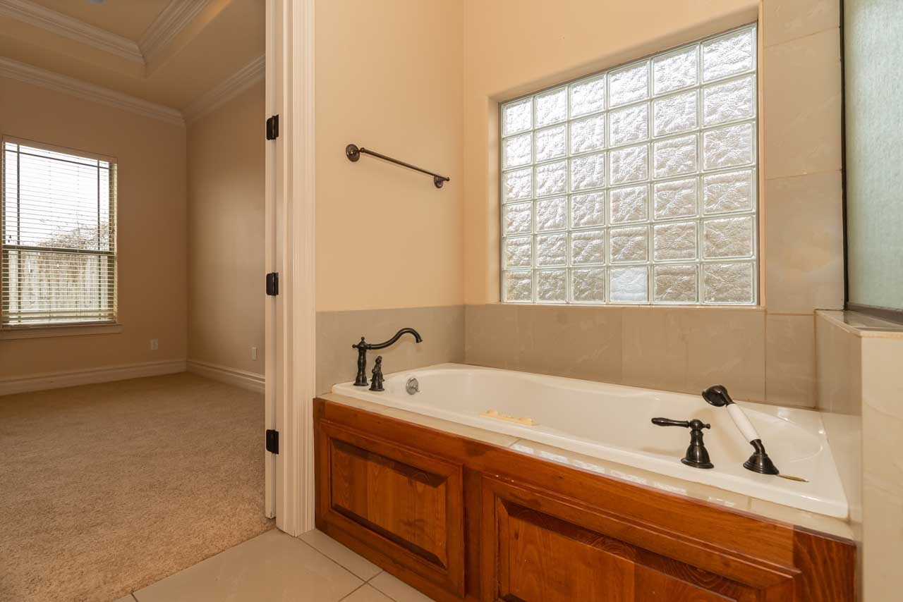 7 Stonebrook Court Beaumont, TX 77706 - Photo 13 of 35 a bathroom with a bathtub and a sink