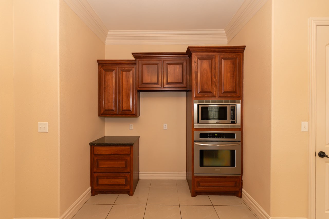 7 Stonebrook Court Beaumont, TX 77706 - Photo 19 of 35 a kitchen with stainless steel appliances and cabinets