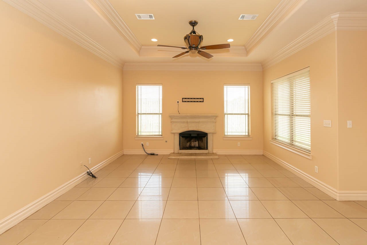 7 Stonebrook Court Beaumont, TX 77706 - Photo 21 of 35 a view of an empty room with a fireplace and a window