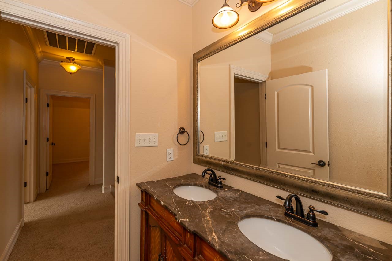 7 Stonebrook Court Beaumont, TX 77706 - Photo 29 of 35 a bathroom with a sink and a mirror