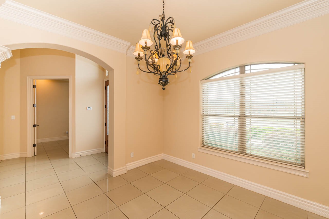 7 Stonebrook Court Beaumont, TX 77706 - Photo 4 of 35 a view of a room with a chandelier and large windows
