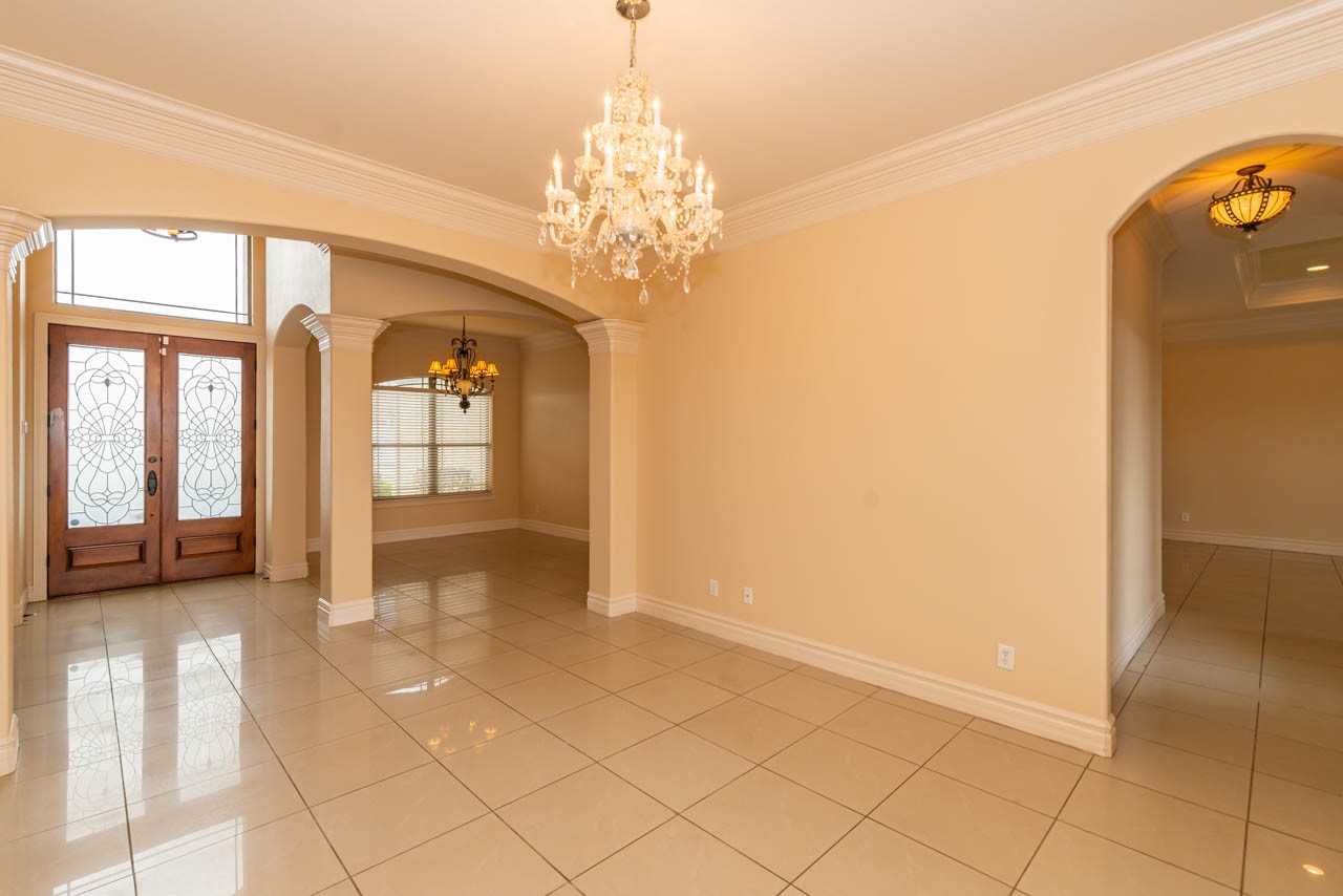 7 Stonebrook Court Beaumont, TX 77706 - Photo 7 of 35 a view of a hallway with chandelier and front door