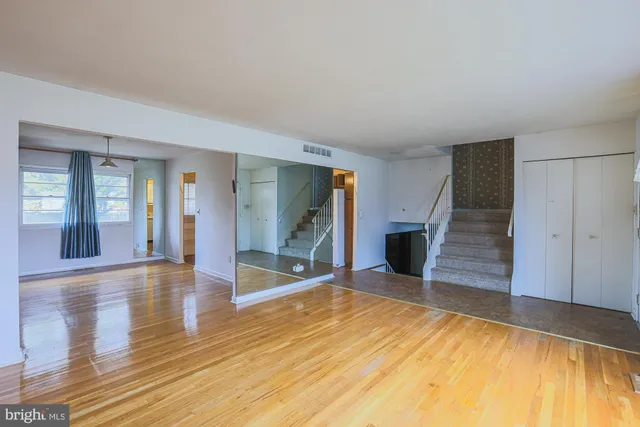 a view of a room with wooden floor and staircase