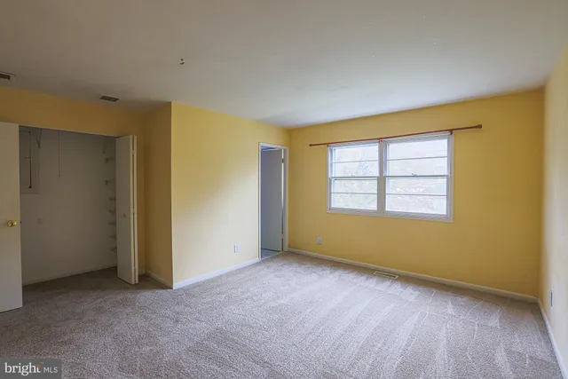 an empty room with a empty space and windows