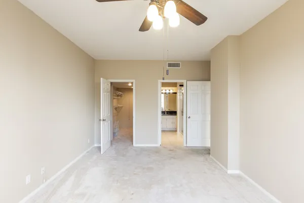 a view of a hallway to a livingroom with furniture and front door