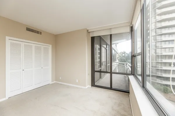 a view of empty room with floor to ceiling window