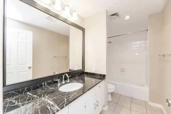 a white bath tub sitting next to a white toilet