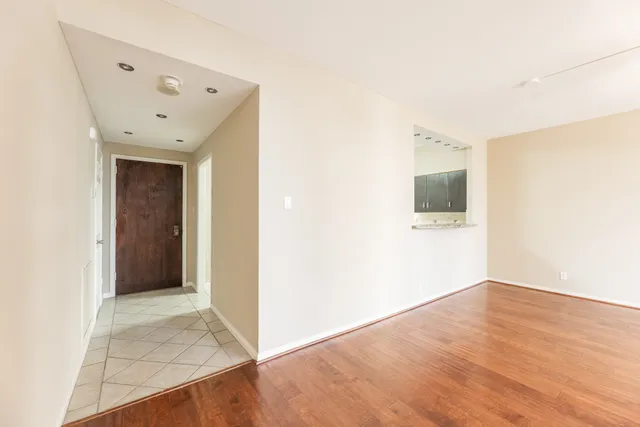 a view of an empty room with wooden floor