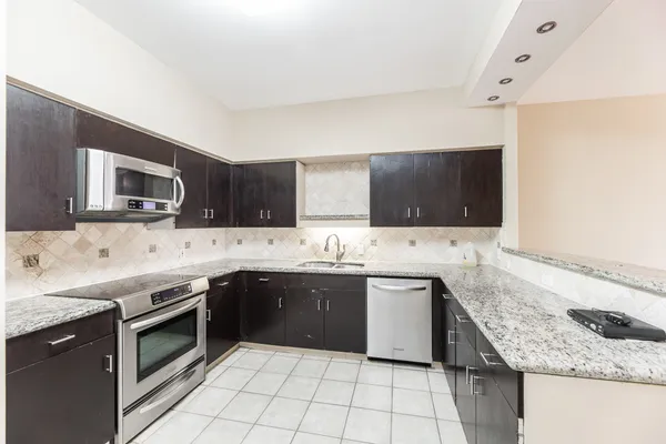a kitchen with a sink and a microwave