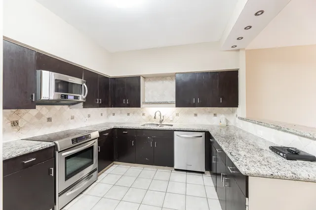 a kitchen with a sink and a microwave