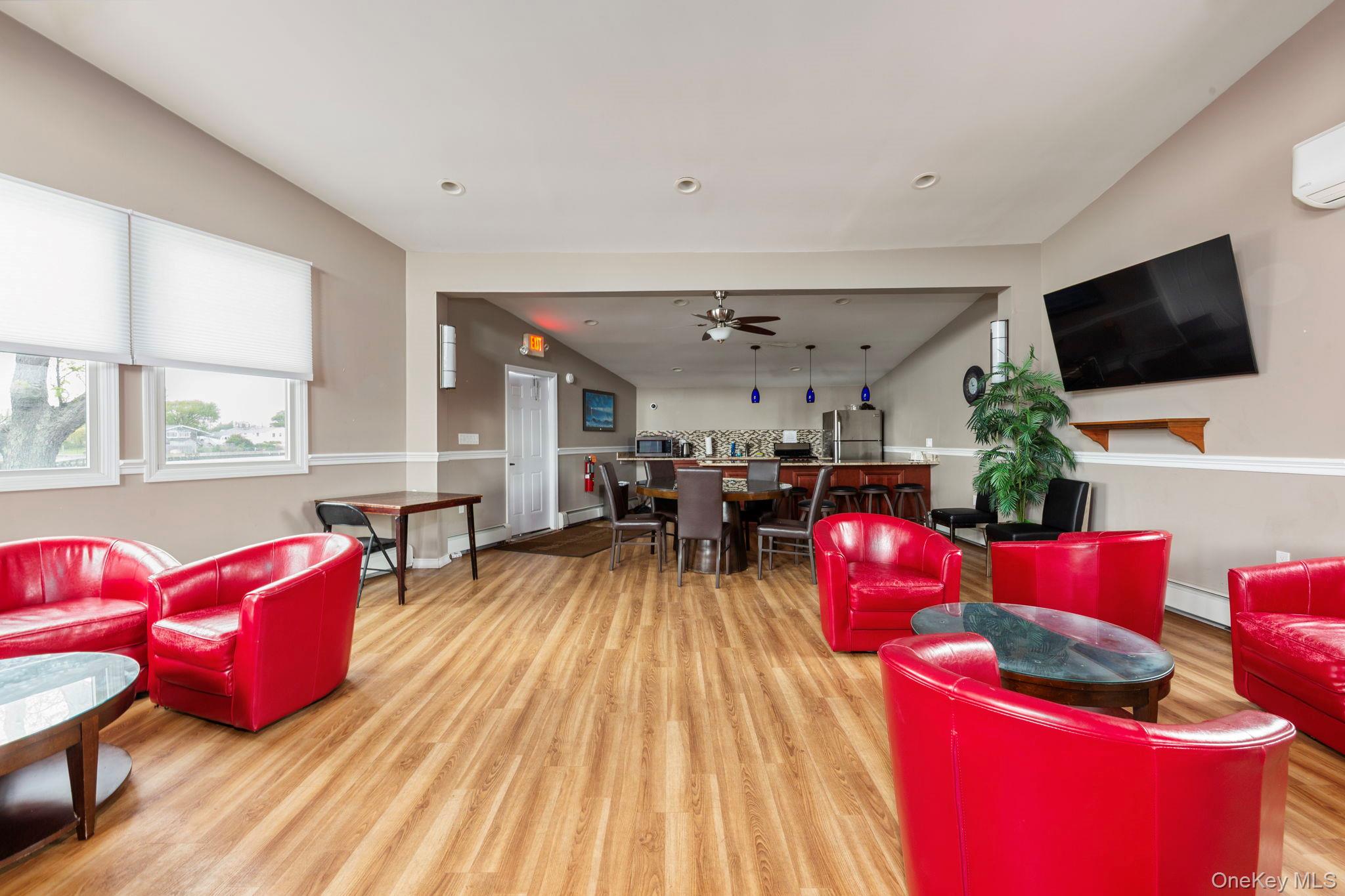 248 Mariners Way Copiague, NY 11726 - Photo 17 of 18 a living room with furniture a flat screen tv and a large window