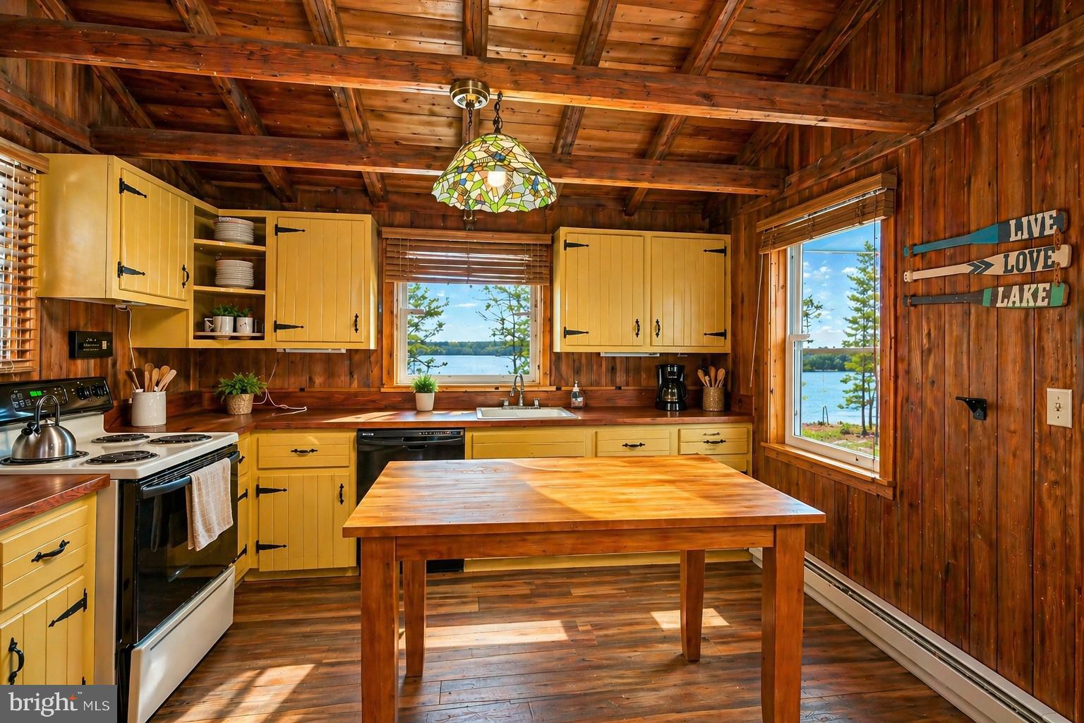 2187 State Park Road Swanton, MD 21561 - Photo 12 of 29 a kitchen with a stove a sink and a refrigerator
