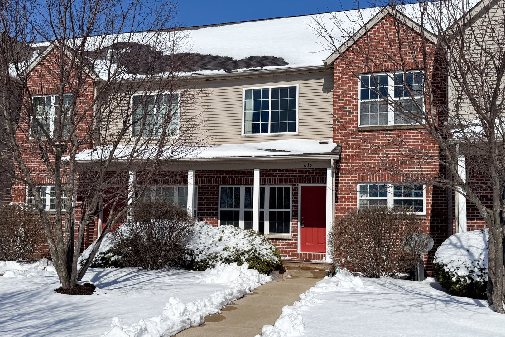 635 Stonegate Drive Sycamore, IL 60178 - Photo 1 of 19 a front view of a house with garden and seating area