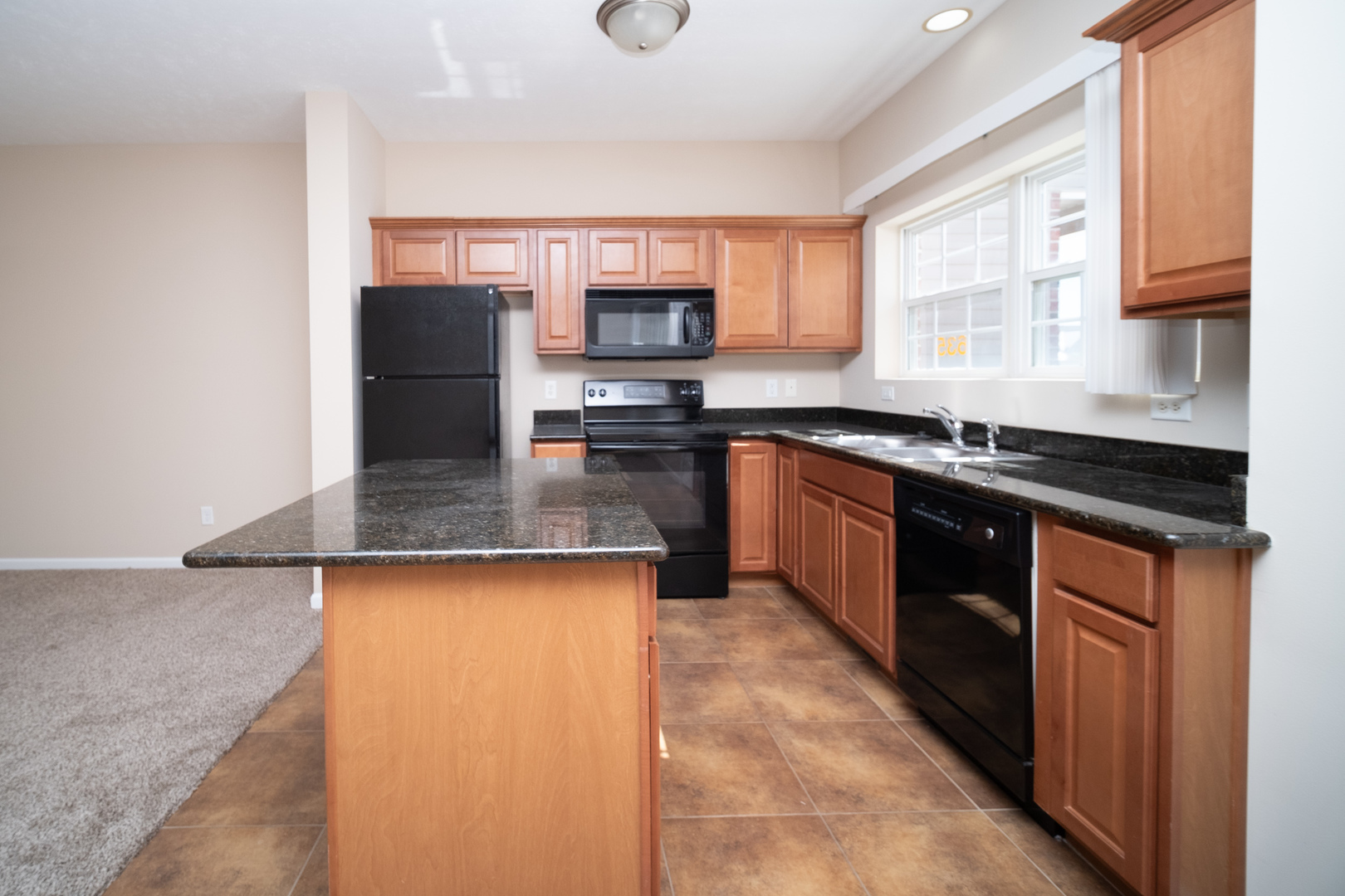 635 Stonegate Drive Sycamore, IL 60178 - Photo 2 of 19 a kitchen with stainless steel appliances granite countertop a sink stove and refrigerator